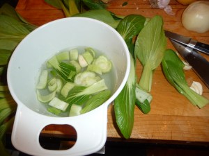 Washing chopped pak choi -soil falls to the bottom of the bowl